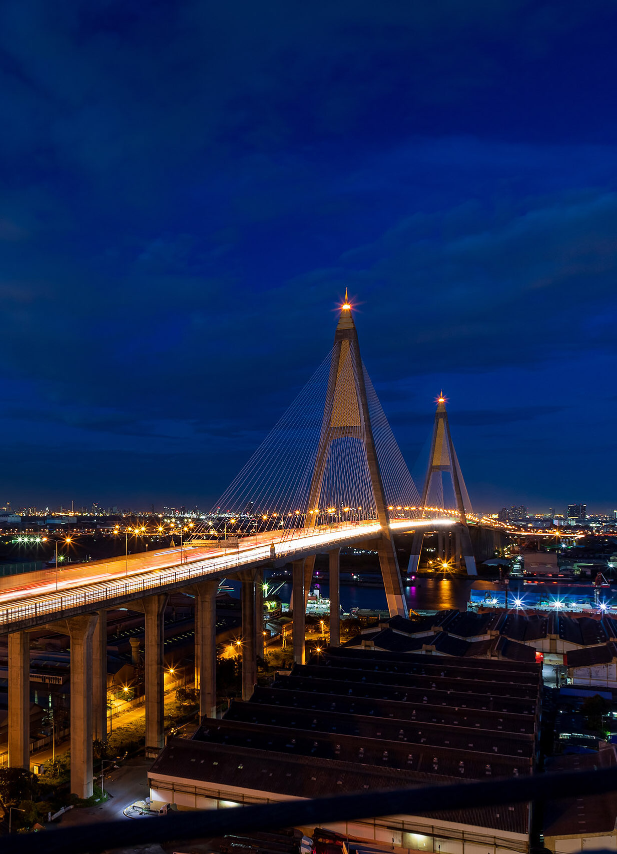 Large suspension bridge over Chao Phraya river with traffic at t